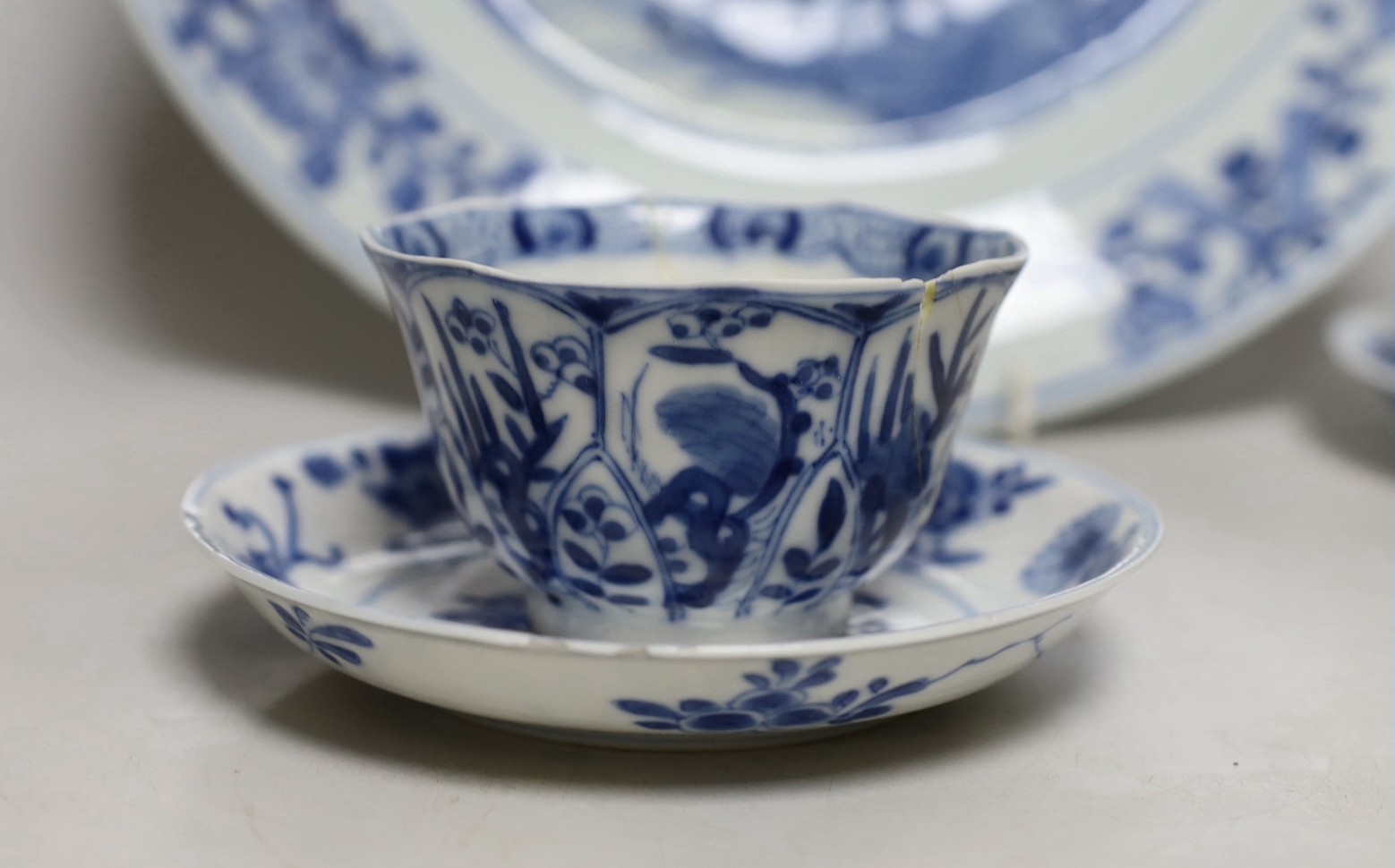 A Chinese blue and white landscape dish, Qianlong period 31cm diameter, together with a similar pair of tea bowls and saucers